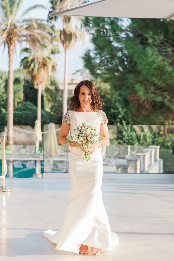 Bride makes her way to her ceremony at Domotel Agios Nikolaos in Sivota