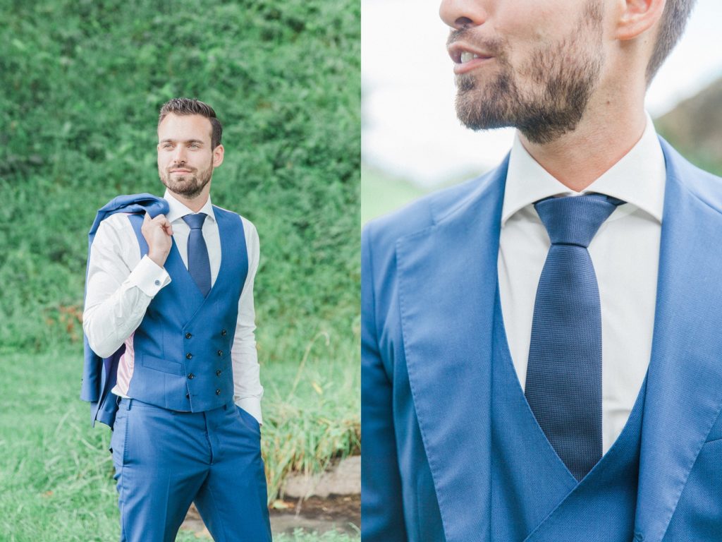 Portraits of a Dutch groom in a blue Oger suit at Fort Altena in The Netherlands