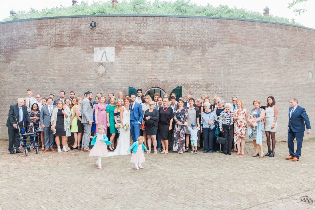 Wedding party pictured outside Fort Altena wedding venue in The Netherlands