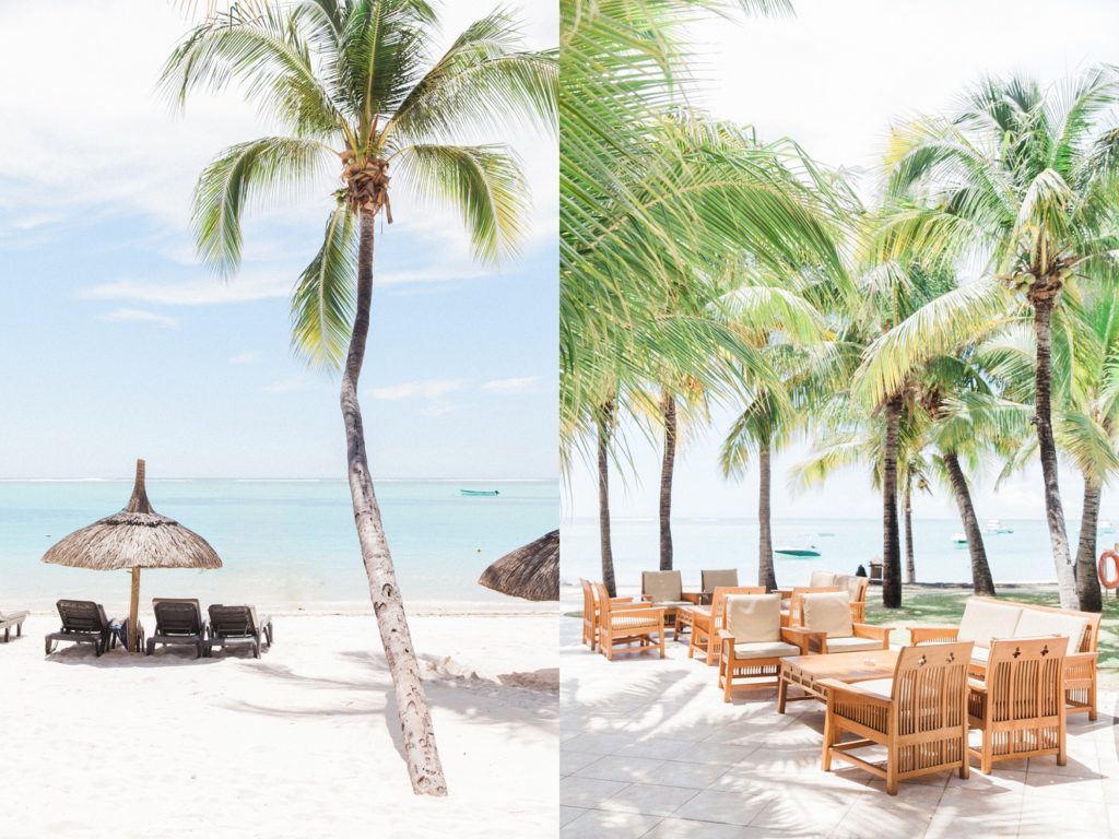 White sandy beach, palm trees and seating at Dinarobin Beachcomber Golf Resort & Spa in Mauritius