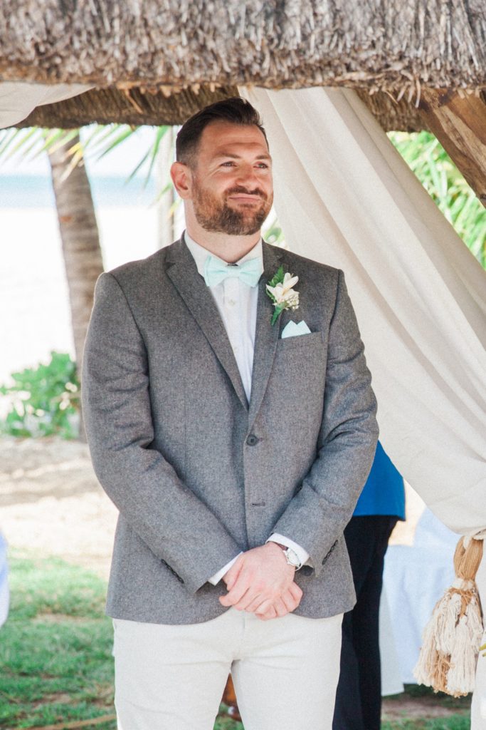Groom smiles as he watched his bride walk down the aisle