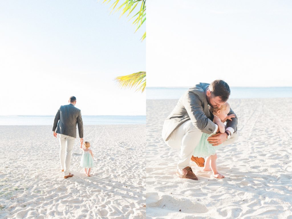 Groom takes his daughter for a walk on the beach after his destination wedding in Le Morne, Mauritius