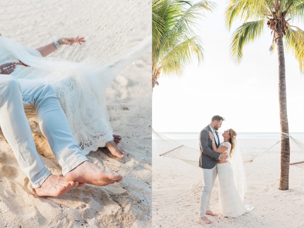 Bride and groom hug on the beach in front of hammocks in Mauritius