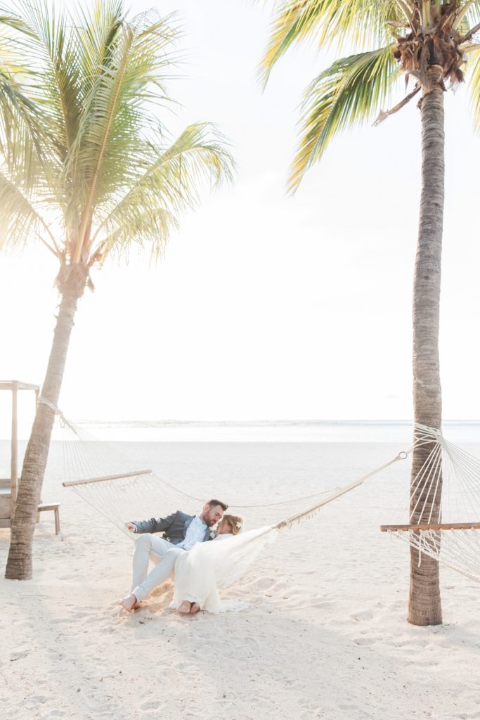 Bride and groom relax in a hammock after their destination wedding in Mauritius