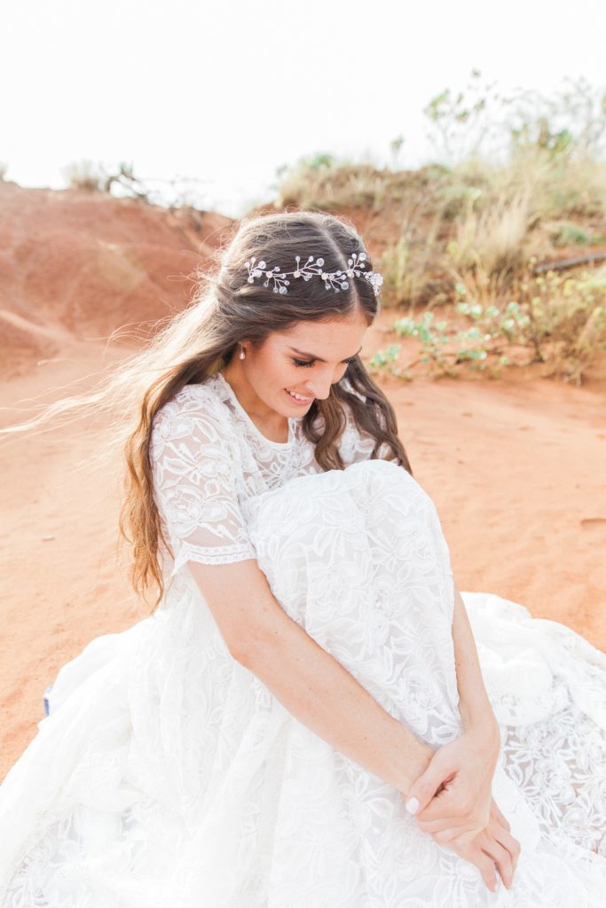 Bride sitting in the Red Desert in South Africa wearing a Chanelle Wright gown