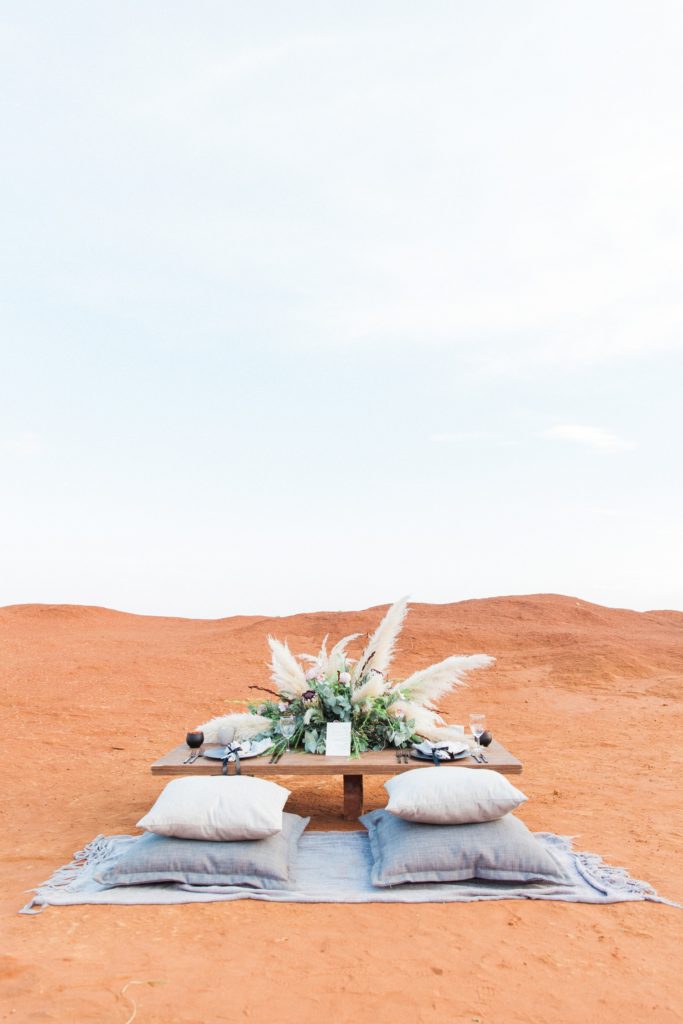 Moroccan style picnic wedding table with pampas and protea flower arrangement in the Red Desert