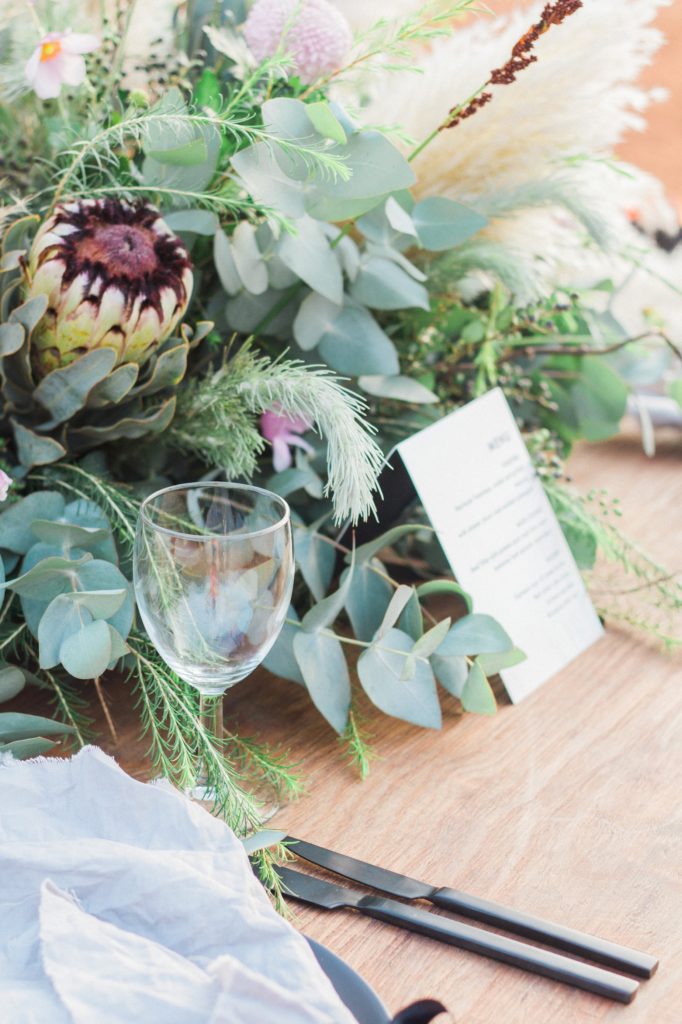Pampas and protea centrepiece on a Moroccan style picnic wedding table in the Red Desert