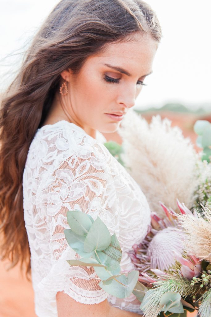 Bride wearing a Chanelle Wright gown with her pampas and protea bouquet