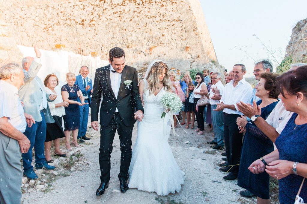Couple are showered in rice as they leave the church in Santa Maura Castle in Lefkada
