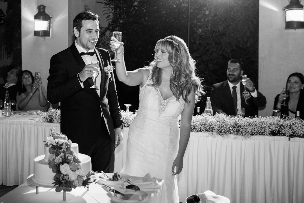 Couple raise a toast to their guests at Ionian Blue Resort Hotel and Spa