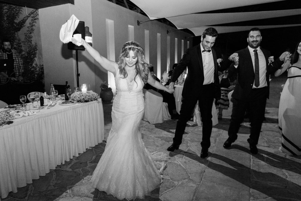 Bride leads the traditional dancing at her Ionian Blue Hotel wedding on Lefkada in Greece