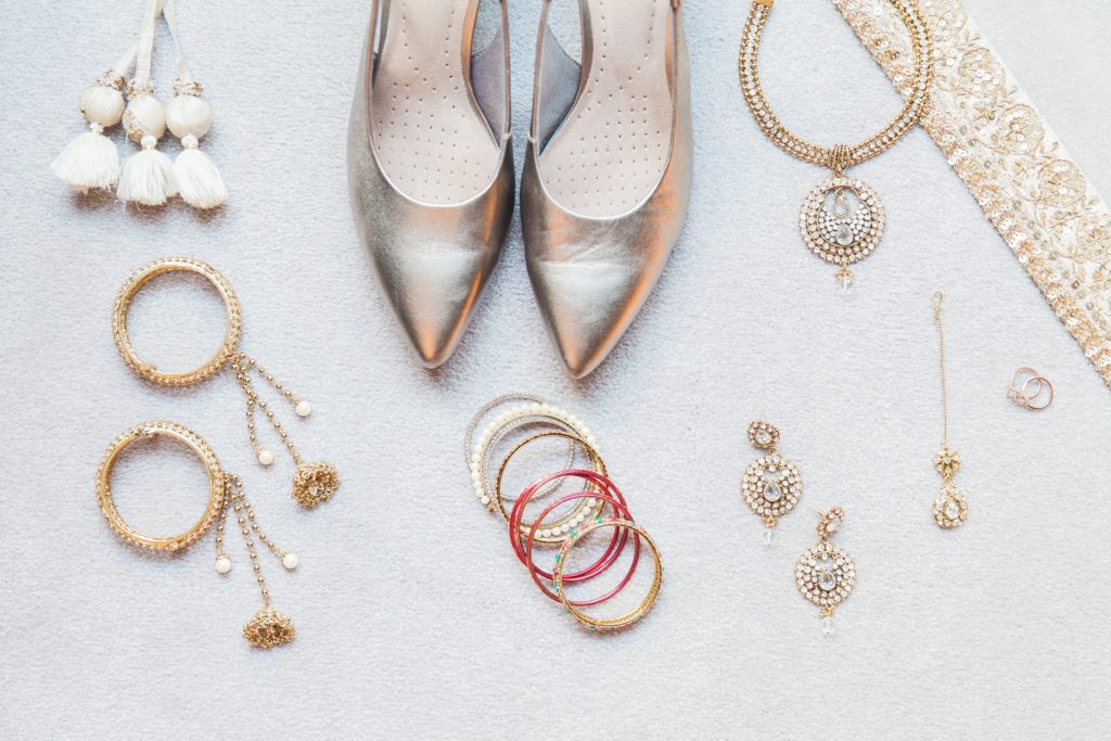 Flatlay of an Indian brides wedding shoes and gold jewellery