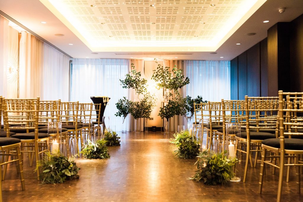 Mixed culture ceremony decor with foliage and candles at a South Place Hotel wedding in London
