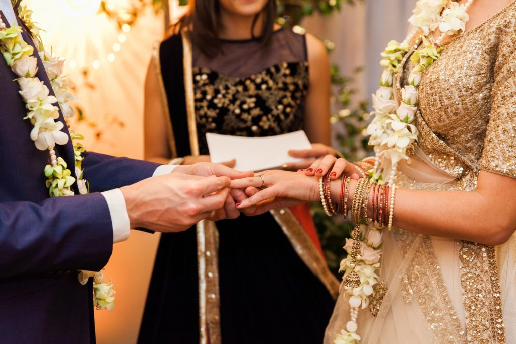 Jewish groom and Indian bride exchange vows during their mixed culture ceremony in London