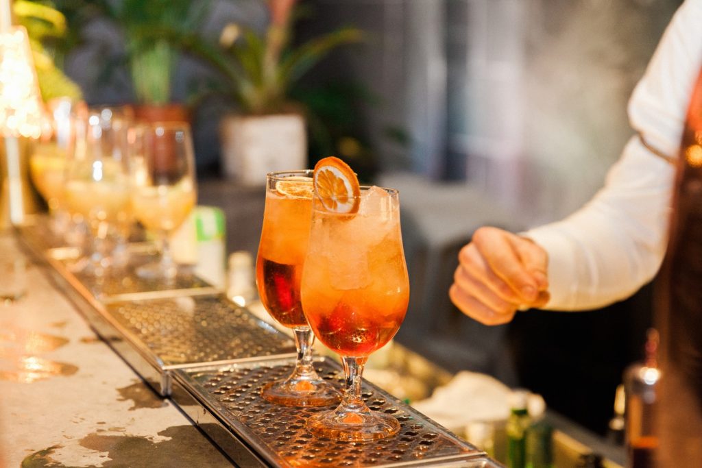 Orange cocktails being made at the Secret Garden bar in South Place Hotel