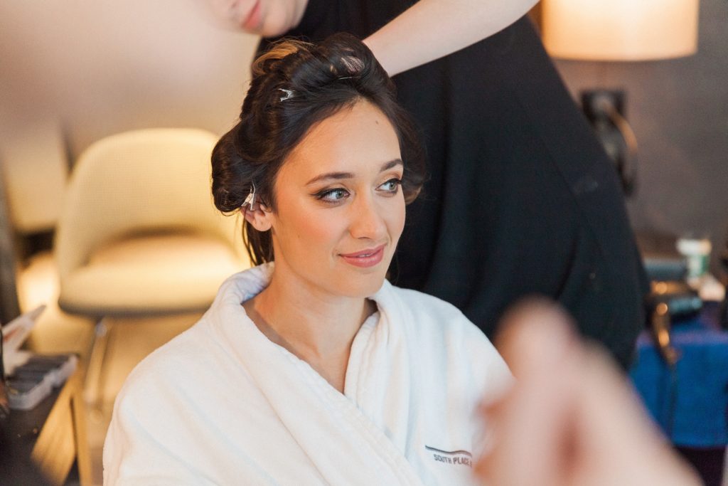 Indian bride getting her hair and make up done on the morning of her South Place Hotel wedding in London