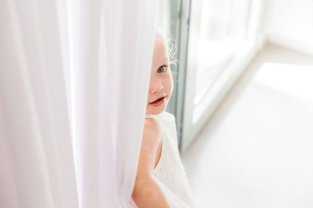 Flower girl plays hide and seek on the morning of her parents villa elopement