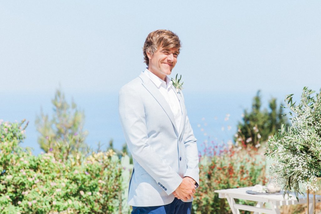 Groom smiles as the bride arrives at their villa elopement ceremony