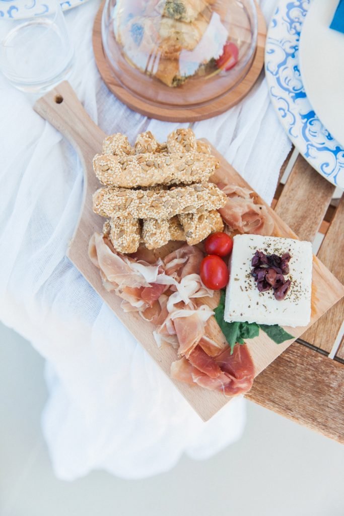 Cutting board with meats, Greek pastries and feta