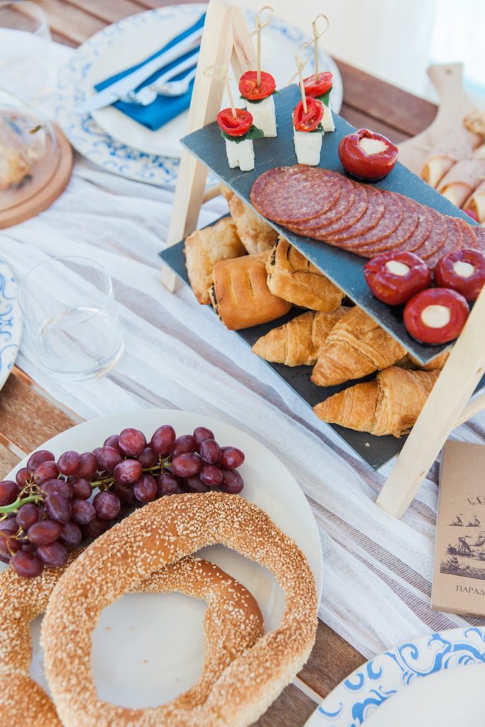 Picnic style wedding breakfast with pastries, meats, stuffed peppers and fruit