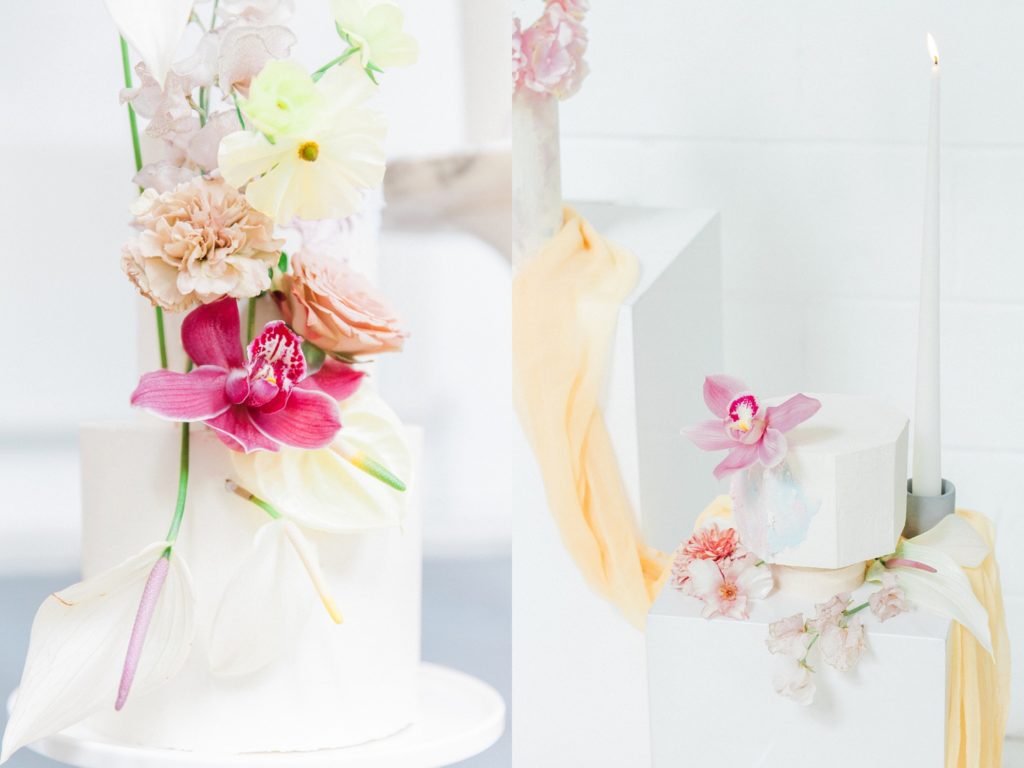 Colourful flower toppers on multi-sized white cakes by Avant Garde Cake Studio
