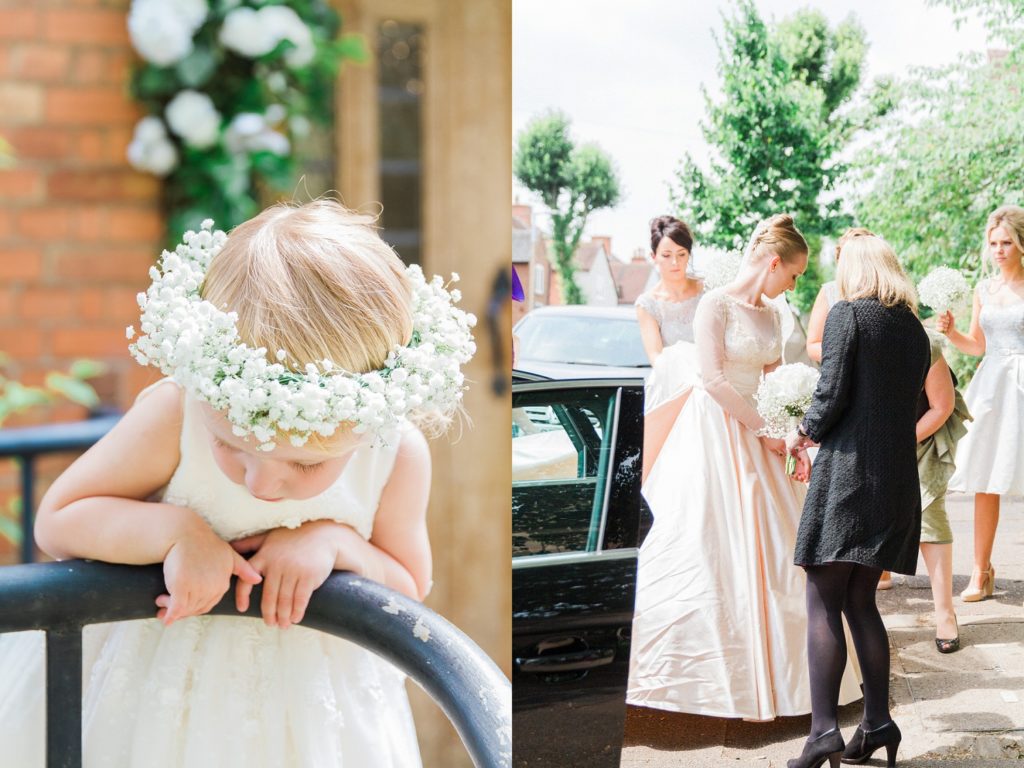 Flowergirl stands at the door of the church wearing a gypsophila crown while the bride gets out of the car
