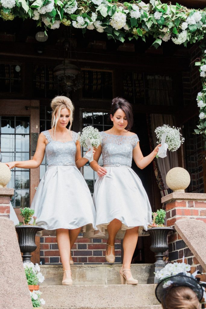 Bridesmaids arrive at a wedding reception in the garden of a private residence