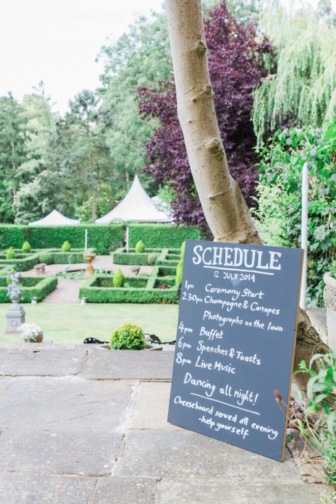 Wedding schedule on a chalk board in the garden in Leicestshire