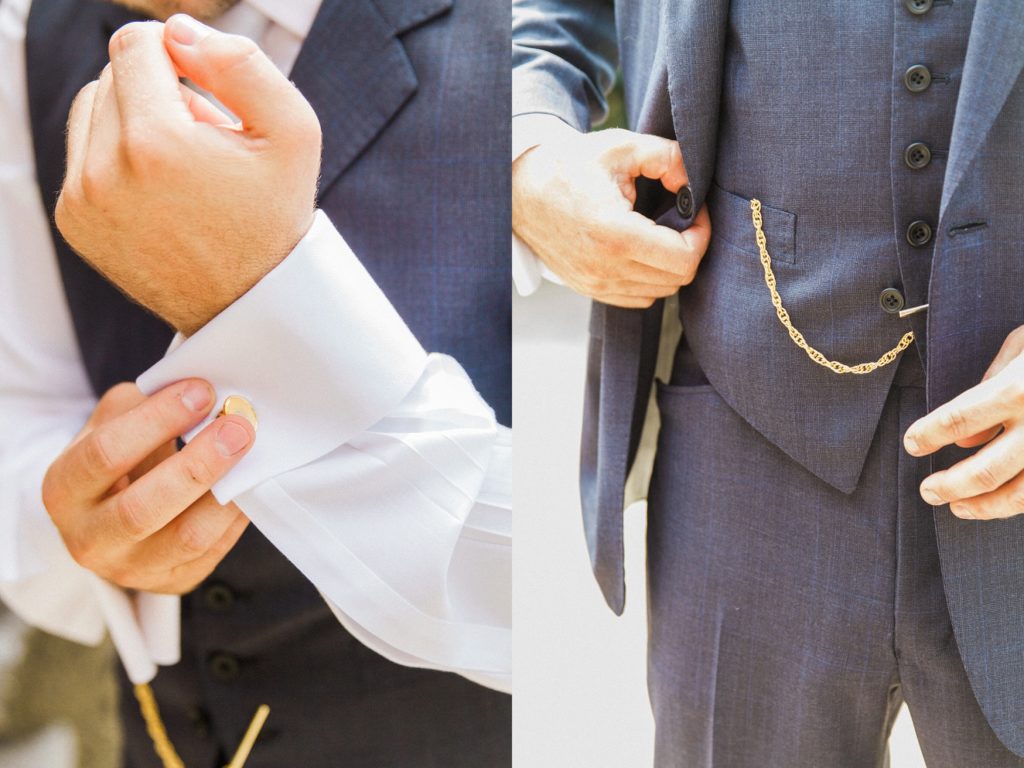Groom fastens his cufflinks and jacket buttons