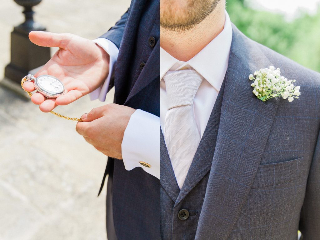 Groom inspects his pocket watch and Gypsophila buttonhole