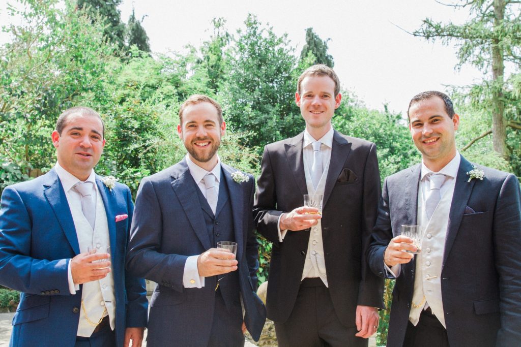 Groom poses with his groomsmen on the morning of his wedding