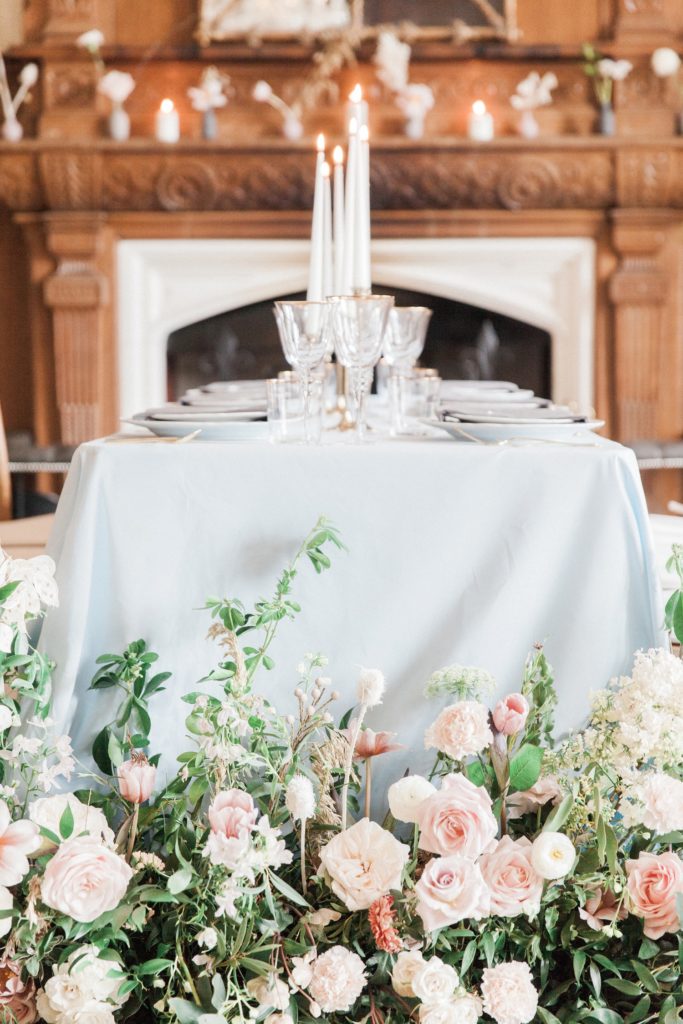 Wild flower floor arrangements and pastel table decor at a Froyle Park wedding