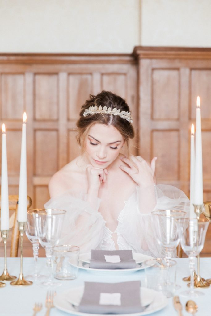 Bride sitting at an elegant reception table at her Froyle Park wedding