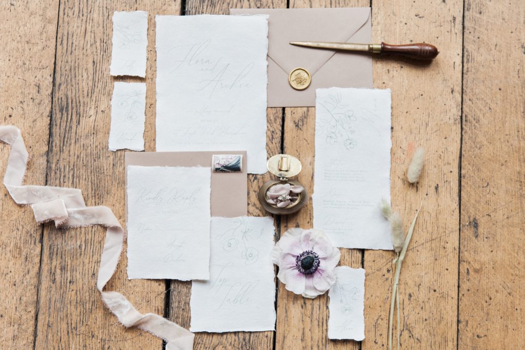 Flatlay of wedding stationery by Abbie Worton Design in neutral colours