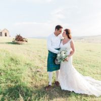 Bride and Groom in a Kilt on the hills at their pistachio and white wedding at Lake Eland Game Reserve