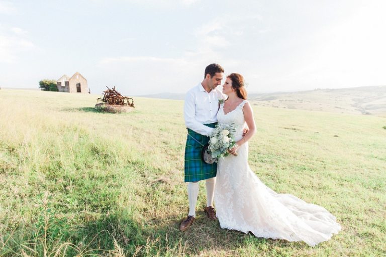 Bride and Groom in a Kilt on the hills at their pistachio and white wedding at Lake Eland Game Reserve