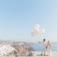 Bride and Groom with Giant White Balloons During their Santorini Elopement