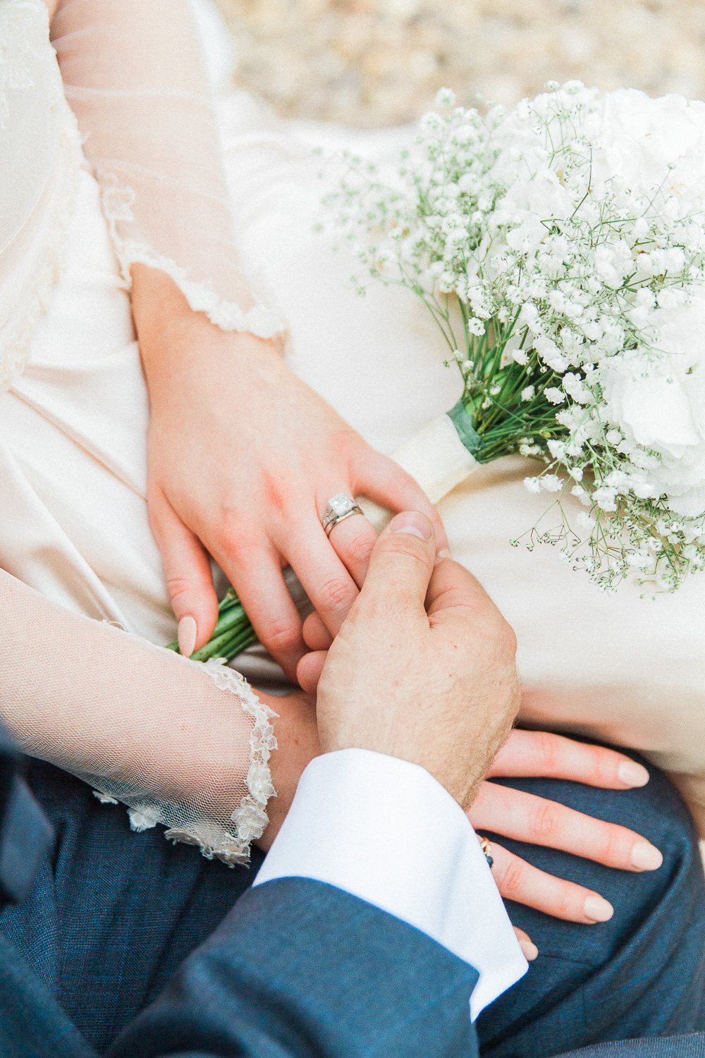 Couple holding hands showing the brides diamond ring