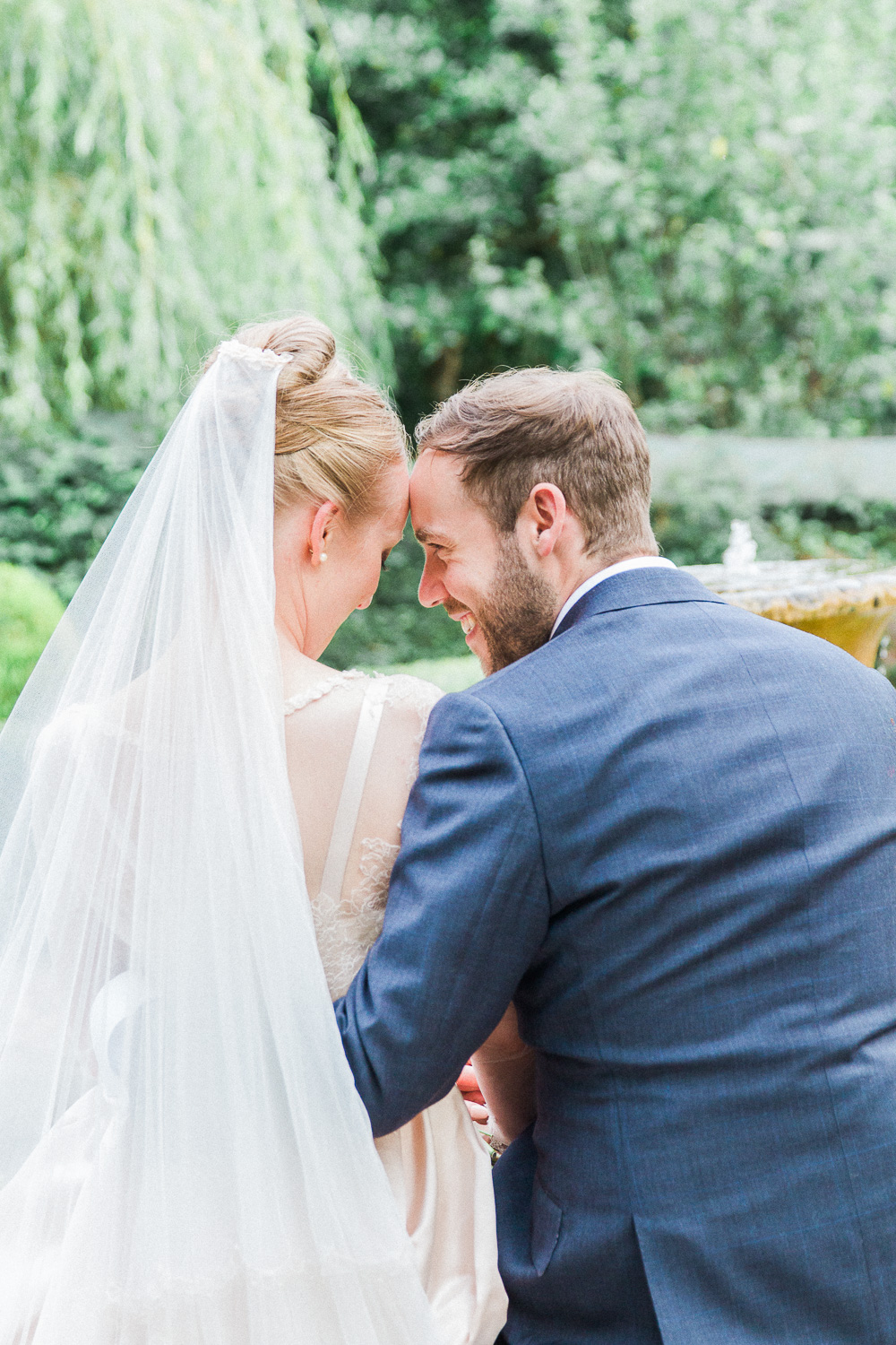 Bride and groom sitting together at their English garden wedding