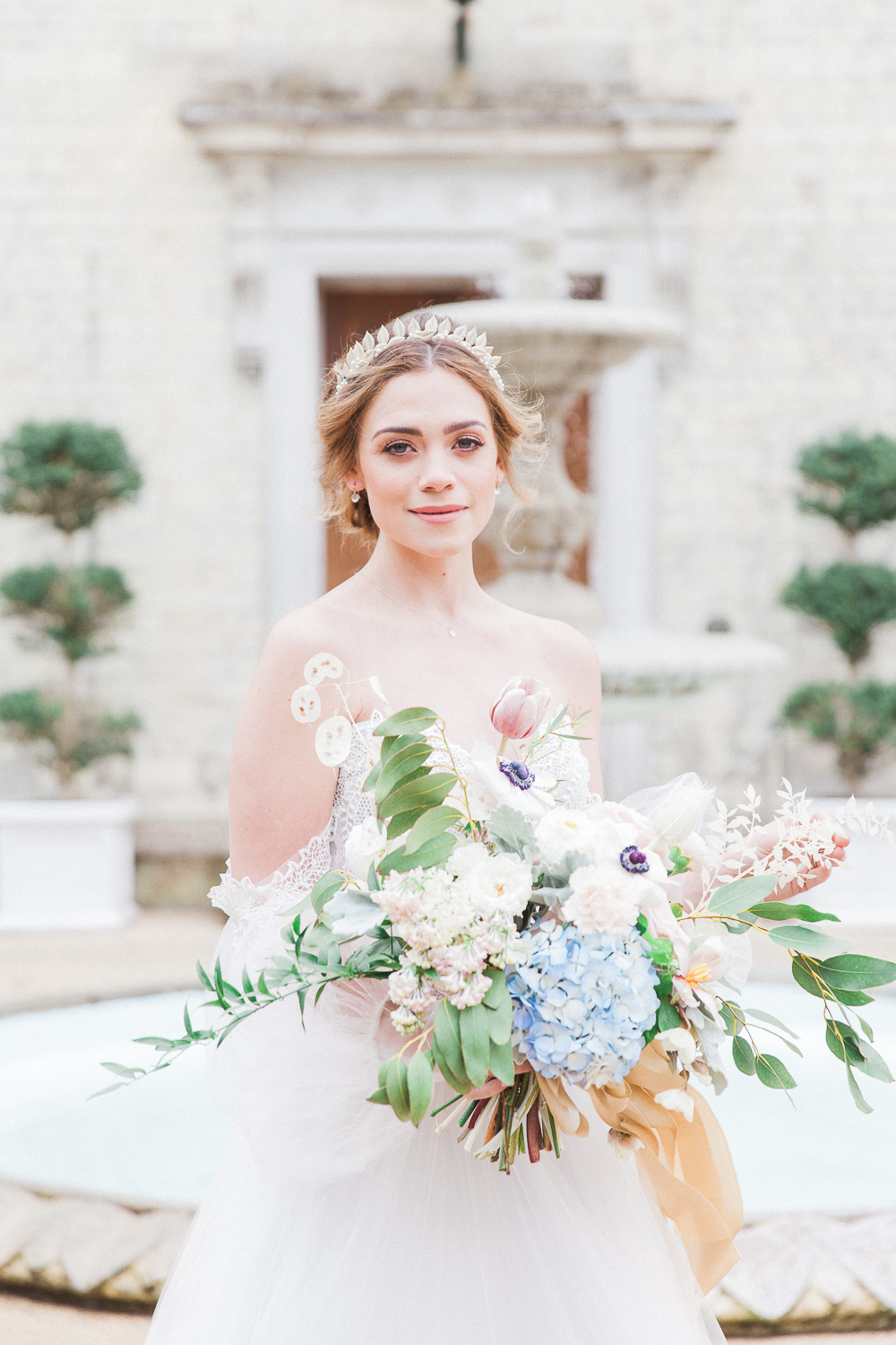 Bride holding her bouqet in front on Froyle Park wedding venue in the UK