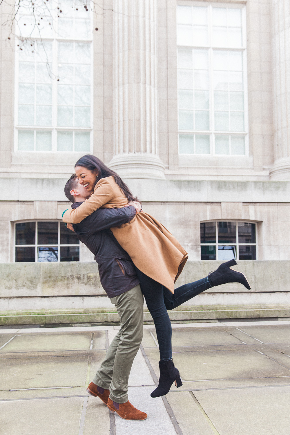 Groom lifting bride during their engagement shoot in London