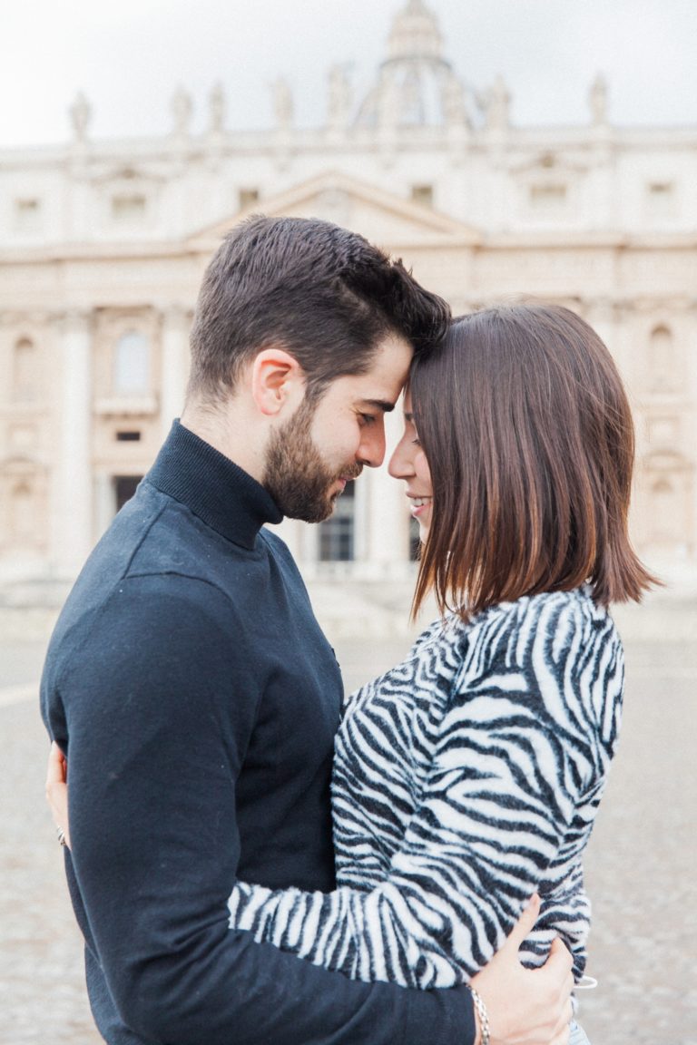 Couple embrace with St. Peter's Basilica in the background during their Rome couple photography session