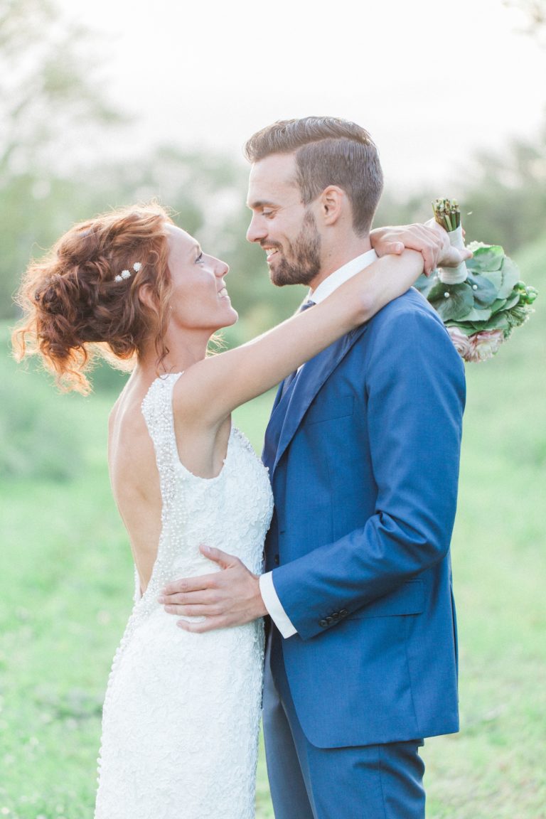 Dutch bride and groom smile at each other during their Fort Altena wedding