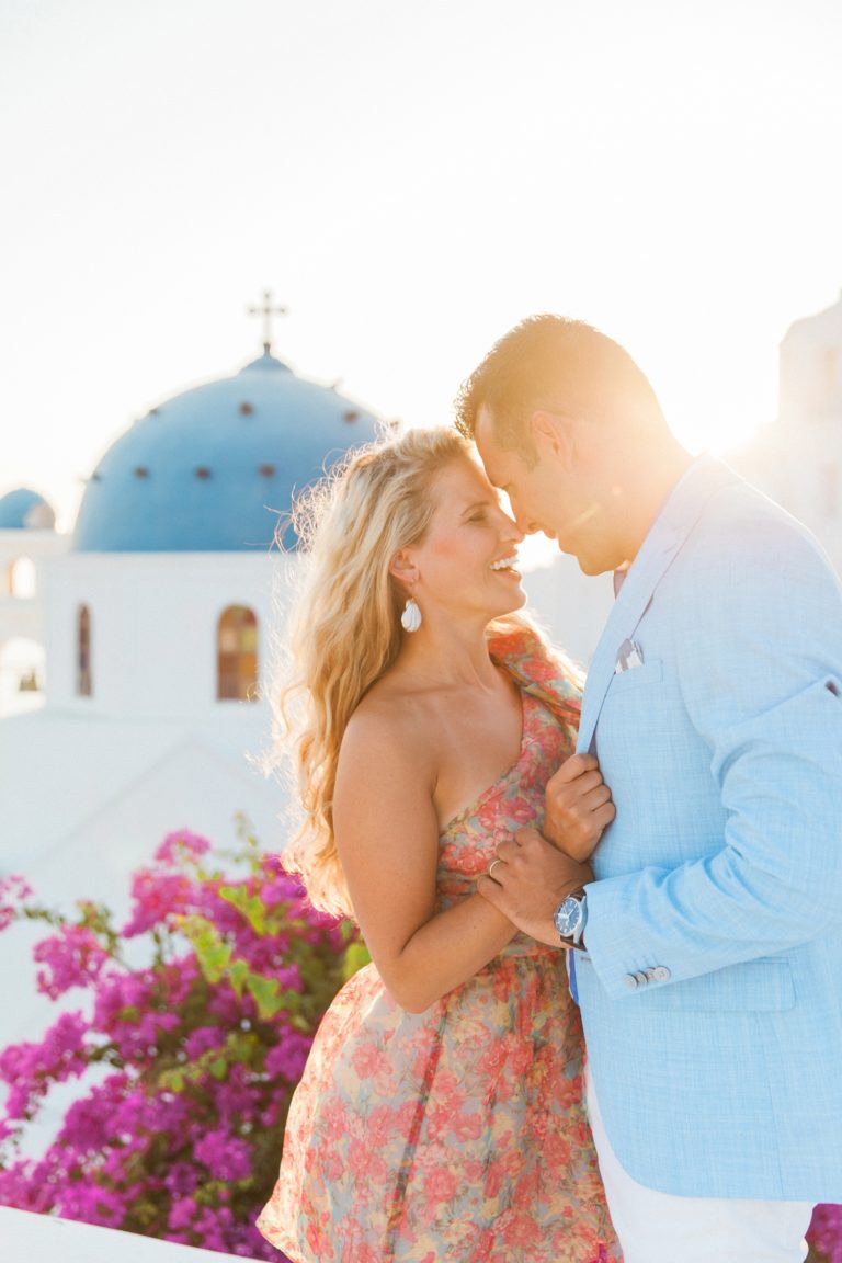 Sunset portraits of a couple in front of a church during their Santorini honeymoon photography session