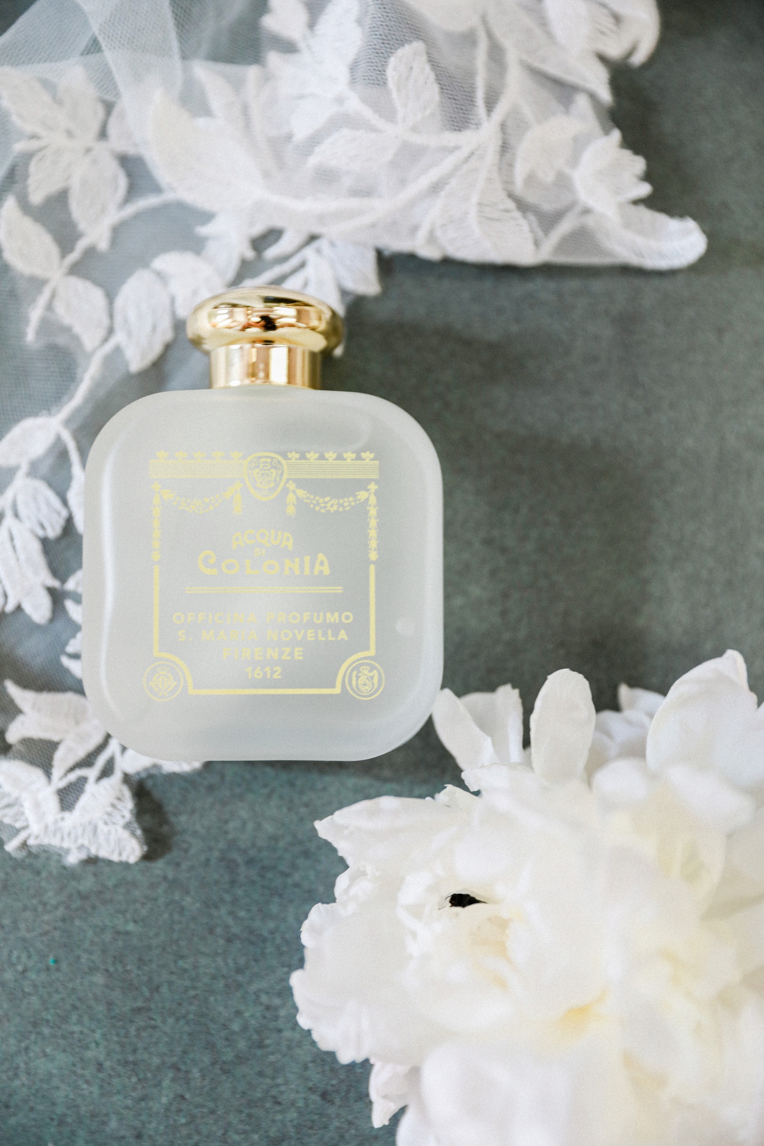 Flatlay of the brides Santa Maria Novella fragrance at veil