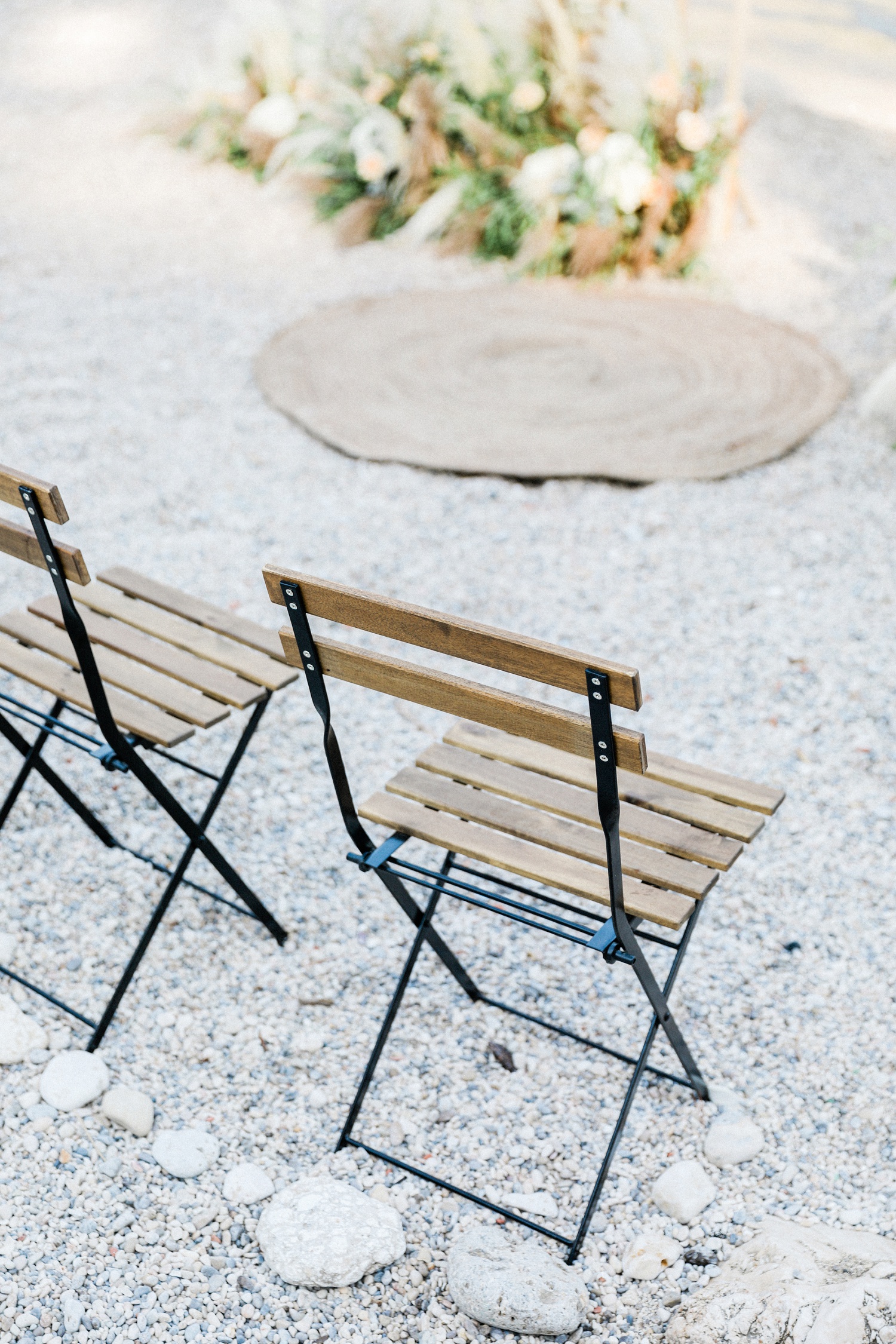 Boho carpet and wooden chairs at a beach wedding in Parga