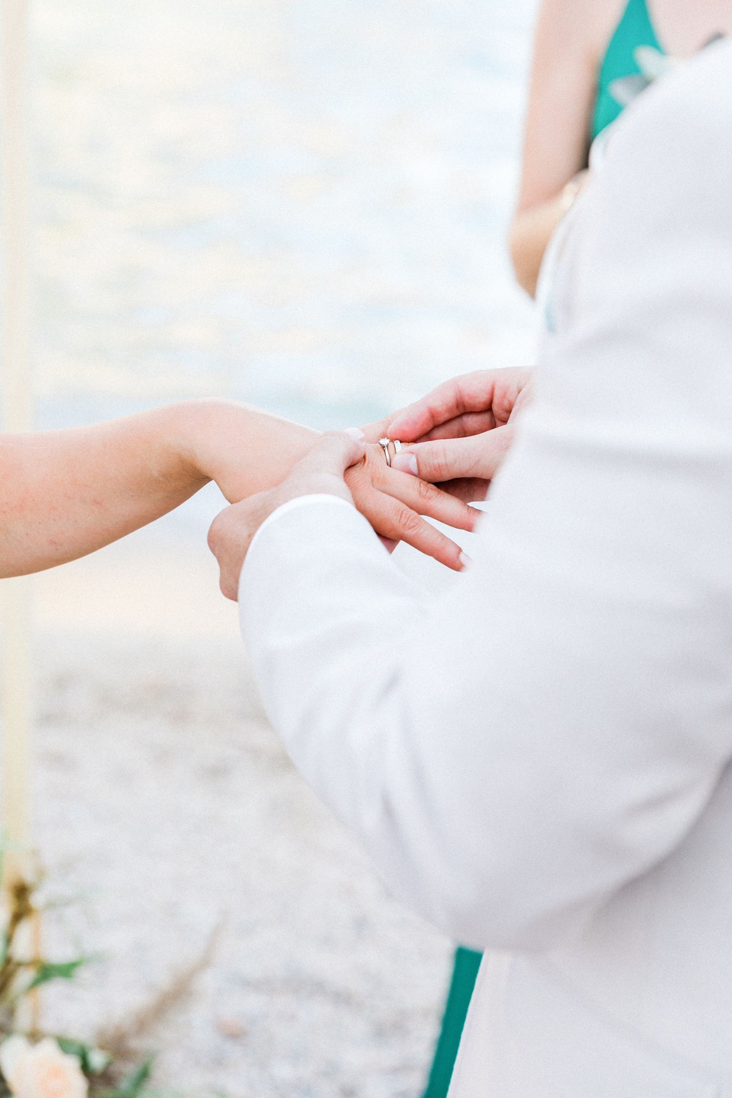 Couple exchange rings during their beach wedding in Parga