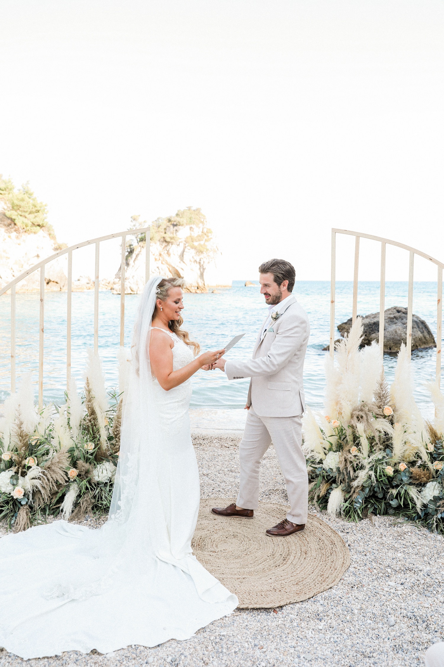 Couple exchange vows during their beach wedding in Parga