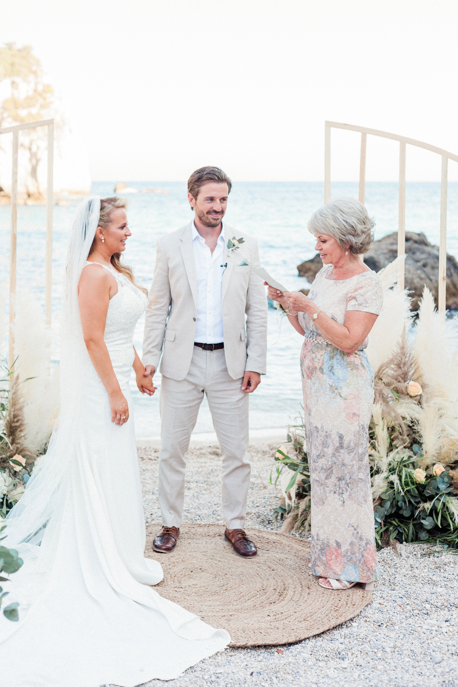 Mother of the bride does a reading during her daughters boho wedding in Parga