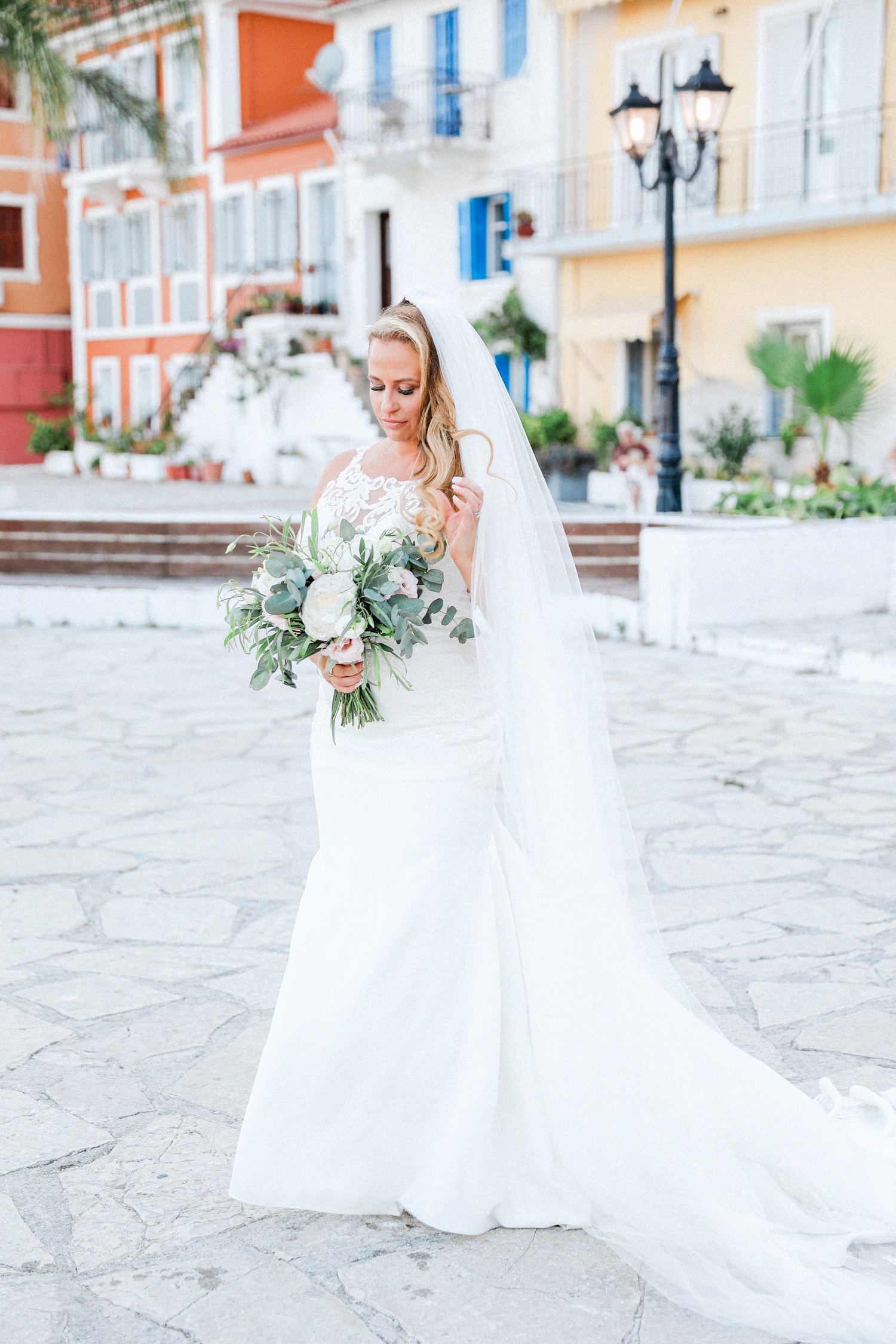 Bride wearing a Stella York gown holding her bouquet in Parga